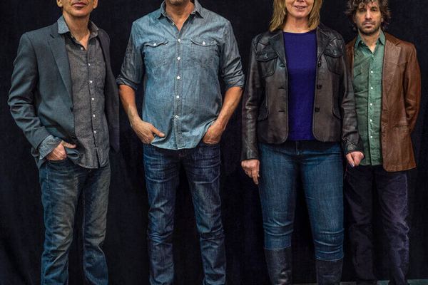 The Jayhawks — four band members in casual clothes against dark background