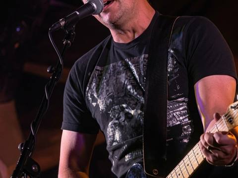 Close-up of lead vocalist singing and playing Telecaster at an intimate show, Visualz photo