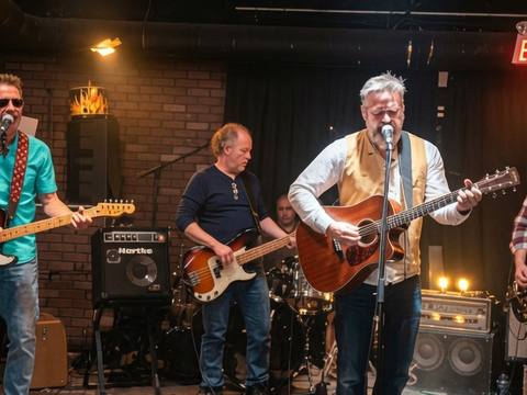 The Threads live at a brick-wall venue, full band in action